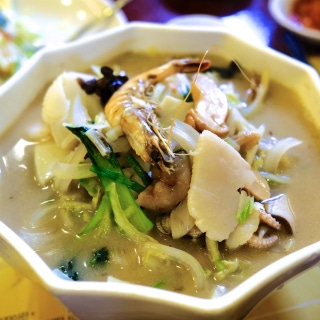 Seafood noodle soup in white broth