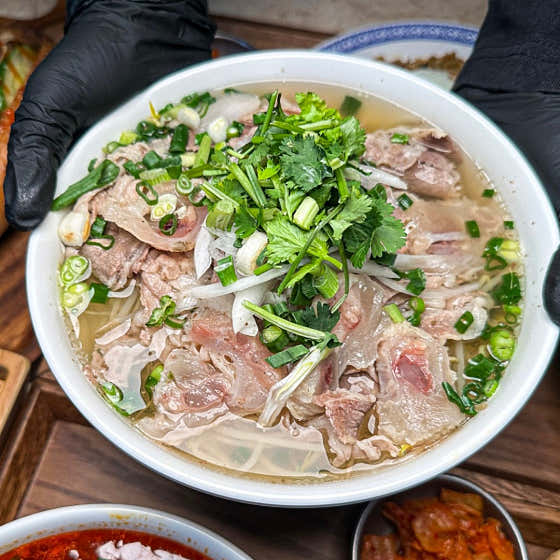 Rice noodles topped with meat and scallions at Vietnamirang
