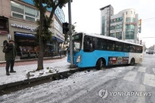 눈길에 미끄러져 신호등 들이받은 버스