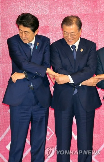 손 잡는 문 대통령과 아베 총리