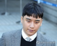 굳은 표정을 법원 나서는 승리