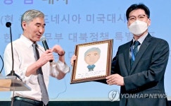 캐리커처 선물 받는 성김 대사