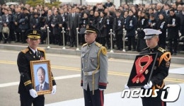 연단으로 향하는 YS 영정과 훈장