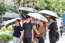 따가운 햇빛 피해 양산 아래로