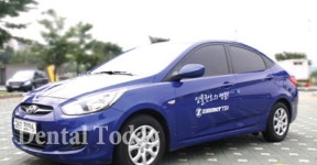 거인씨앤아이, 회사 차에 ‘임플란트 명품’ 로고