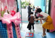 교장 선생님 꽃다발 받고 등교하는 초등생