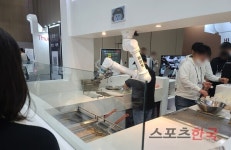 치킨 튀기고·고기 볶고…외식업계, 조리 로봇 속속 도입