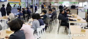 송산3동 공공복합청사 직원식당 | 일렬로 앉아 식사하는 정부서울청사 직원들