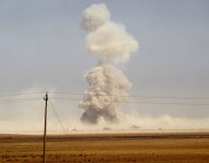 A picture taken on October 17, 2016 from the top of Mount al-Shourah shows smoke billowing as Iraqi forces deploy in the area... 
