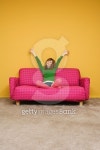 Mid-adult woman sitting on couch stretching 이미지 (78373786) - 게티이미지뱅크 Mid-adult woman sitting on couch stretching