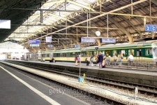 Wide shot of train station with tracks and people waiting for a train in St. Gallen, Switzerland. 이미지 (78025764)... 