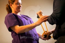 A physical therapist assists a patient with wrist exercises using an exercise band 이미지 (78028975) - 게티이미지뱅크 A... 