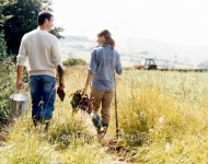 Farming Couple Walking in a Field Holding Bucket, Spade and Vegetables 이미지 (dv1601049) - 게티이미지뱅크 Farming Couple... 