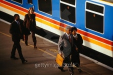 People walking along platform beside train in station 이미지... People walking along platform beside train in station