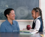 Young girl standing talking to a young female teacher in class 이미지 (blddb_a0058) - 게티이미지뱅크 Young girl standing... 