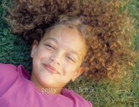 Young girl lying on a lawn looking at camera grinning 이미지 (blddb_a0113) - 게티이미지뱅크 Young girl lying on a lawn... 