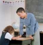 Young female teacher watching a young girl write 이미지 (blddb_a0077) - 게티이미지뱅크 Young female teacher watching a young... 
