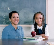 Young female teacher and a young girl in a class room looking at camera 이미지 (blddb_a0003) - 게티이미지뱅크 Young female... 