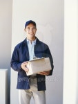 portrait of a delivery man holding a package 이미지 (stk316009rkn) - 게티이미지뱅크 portrait of a delivery man holding a package