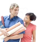 portrait of a young man holding rolls of wall paper with a young woman beside him 이미지 (stk98754cor) - 게티이미지뱅크... 