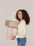 side profile of a young woman holding packages 이미지 (stk316020rkn) - 게티이미지뱅크 side profile of a young woman holding... 