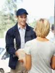 delivery man handing a package to a young woman 이미지 (stk316013rkn) - 게티이미지뱅크 delivery man handing a package to a... 