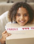 girl sitting on a couch holding a package 이미지 (stk316028rkn) - 게티이미지뱅크 girl sitting on a couch holding a package