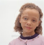 Young girl (8-9) with curly brown hair posing in studio, portrait 이미지 (200315266-001) - 게티이미지뱅크 Young girl (8-9)... 