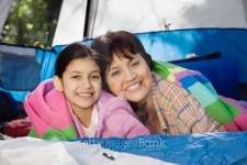 Grandmother and granddaughter laying in tent smiling 이미지... Grandmother and granddaughter laying in tent smiling