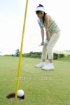 Woman looking at golf ball rolling into hole, Saipan, USA  이미지 (80649306) - 게티이미지뱅크 Woman looking at golf ball... 