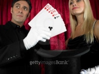 Magician performing card trick with female assistant 이미지 (200311482-001) - 게티이미지뱅크 Magician performing card trick... 