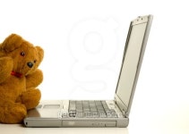 Teddy bear sitting in front of a laptop computer 이미지 (99425846) - 게티이미지뱅크 Teddy bear sitting in front of a laptop... 