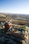 Aerial view of factory with smokestacks and city in distance.... Aerial view of factory with smokestacks and city in distance.