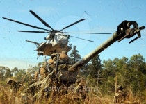An MH-53E Sea Stallion helicopter preparing to lift an M777 105... helicopter preparing to lift an M777 105-mm lightweight Howitzer.