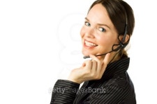 Beautiful customer service agent smiling during phone conversati... Beautiful customer service agent smiling during phone conversati