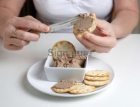 Woman spreading homemade chicken pate on cracker 이미지... 게티이미지뱅크 Woman spreading homemade chicken pate on cracker
