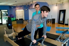 Pilates Trainer teaching student on the Reformer 이미지 (183579271) - 게티이미지뱅크 Pilates Trainer teaching student on the... 