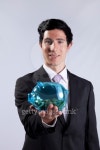 Businessman holding a piggybank full of coins 이미지 (153708560) - 게티이미지뱅크 Businessman holding a piggybank full of coins