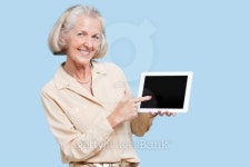 Portrait of senior woman showing tablet PC against blue background 이미지 (159292668) - 게티이미지뱅크 Portrait of senior... 