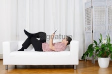 Relaxing and Fun withTablet PC Man on White Sofa 이미지 (175394827) - 게티이미지뱅크 Relaxing and Fun withTablet PC Man on... 