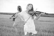 Two young women playing guitar and violin outdoors 이미지 (149727796) - 게티이미지뱅크 Two young women playing guitar and... 