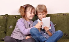 happy little girl and boy playing with tablet pc 이미지... 게티이미지뱅크 happy little girl and boy playing with tablet pc