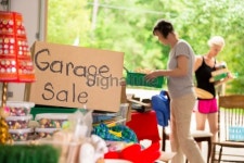 Consumerism:  Adult women shopping at a garage sale in suburbs... Consumerism:  Adult women shopping at a garage sale in suburbs