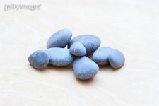 Smooth river rocks on a white wooden background 이미지 (178878807) - 게티이미지뱅크 Smooth river rocks on a white wooden...