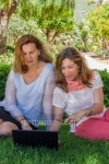 Two women with PC in the garden 이미지 (509141505) - 게티이미지뱅크 Two women with PC in the garden