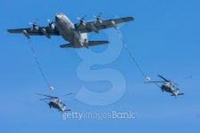 C-130 Hercules Refueling Two HH-60G Pave Hawk Helicopters... C-130 Hercules Refueling Two HH-60G Pave Hawk Helicopters