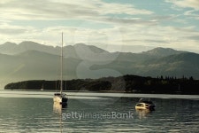 yacht and pleasure boat at sunset with mountains 이미지 (522751533) - 게티이미지뱅크 yacht and pleasure boat at sunset with... 