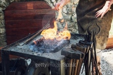 Artistic blacksmith works in the historic blacksmith workshop... Artistic blacksmith works in the historic blacksmith workshop