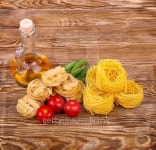 Pasta on the wooden background with tomato, lettuce pepper, olive... 게티이미지뱅크 Pasta on the wooden background with tomato... 