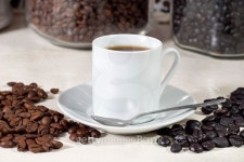 Cup of coffee beside natural roasted and torrefacto coffee beans 이미지 (497956494) - 게티이미지뱅크 Cup of coffee beside... 